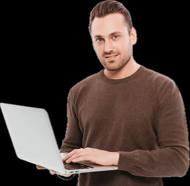 A man standing with an open laptop