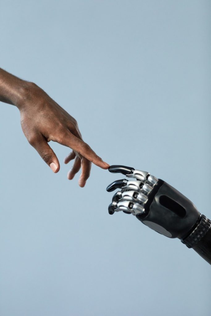 Human and robot hands reaching toward each other