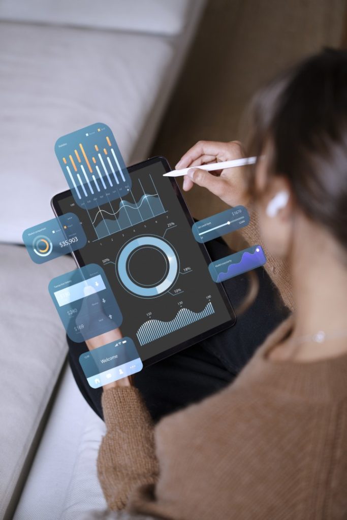 A hand holding a phone showing the Minutes CRM dashboard